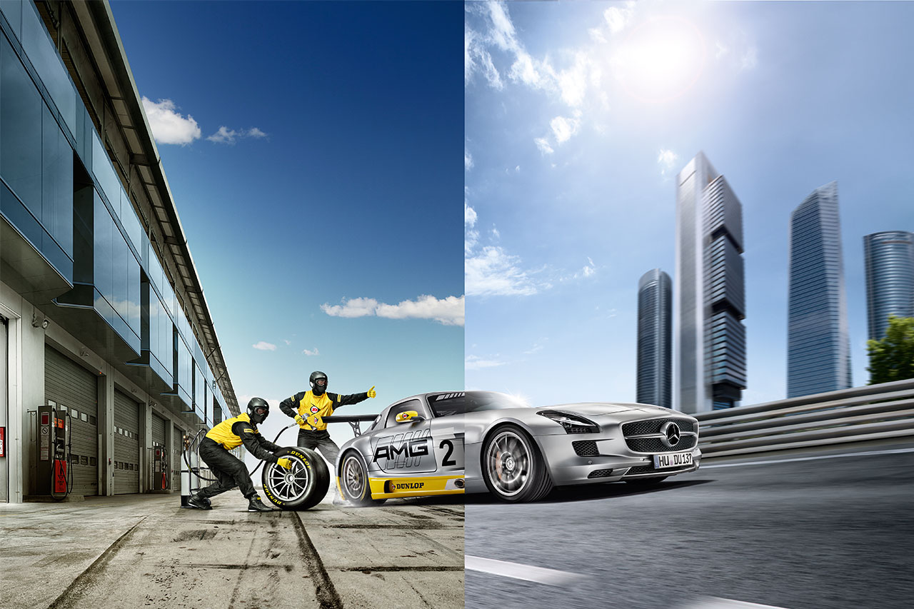 High-End-Bildbearbeitung Dunlop Bildcomposing: geteiltes Bild: links wechseln 2 Automechaniker einen Reifen an einem Rennwagen, rechts erscheint der Wagen als ein Mercedes SLS in schneller Fahrt vor Großstadt-Kulisse
